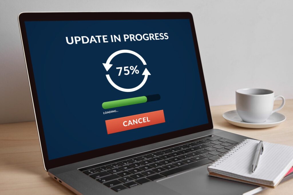 A laptop computer's screen showing the progress of installing new updates.